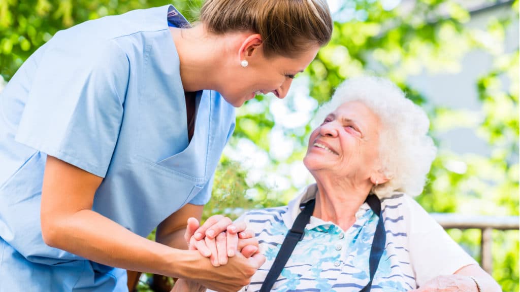 Resident smiling with Nurse