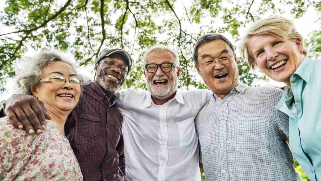 Group of men & women outdoors hugging