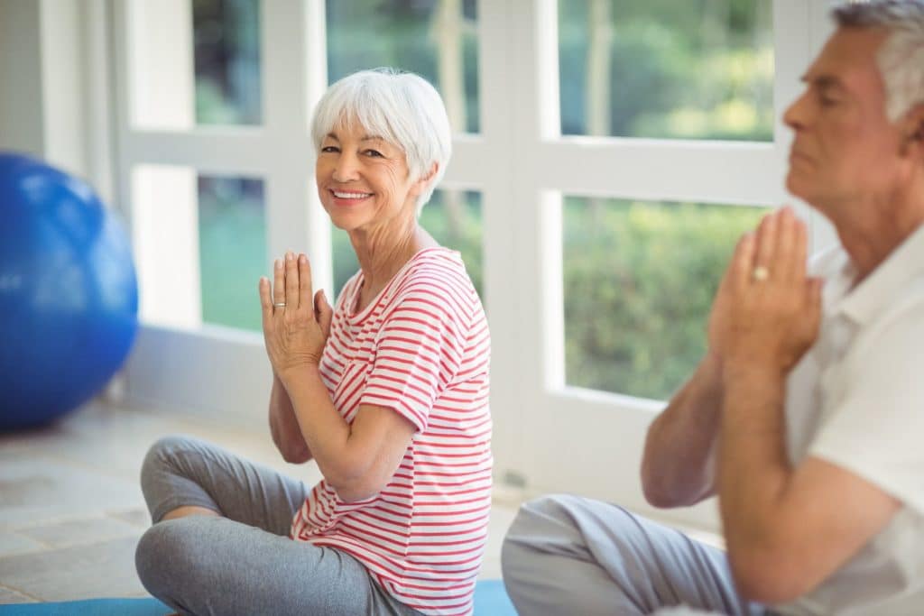 Man & woman doing yoga