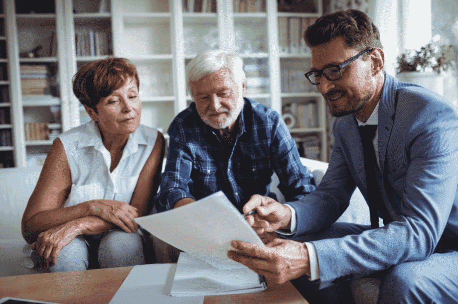 Man & woman reviewing documents with a man