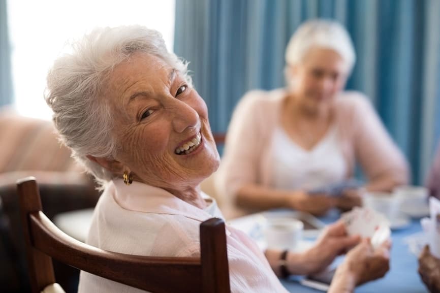 Women sitting at the table playing cards