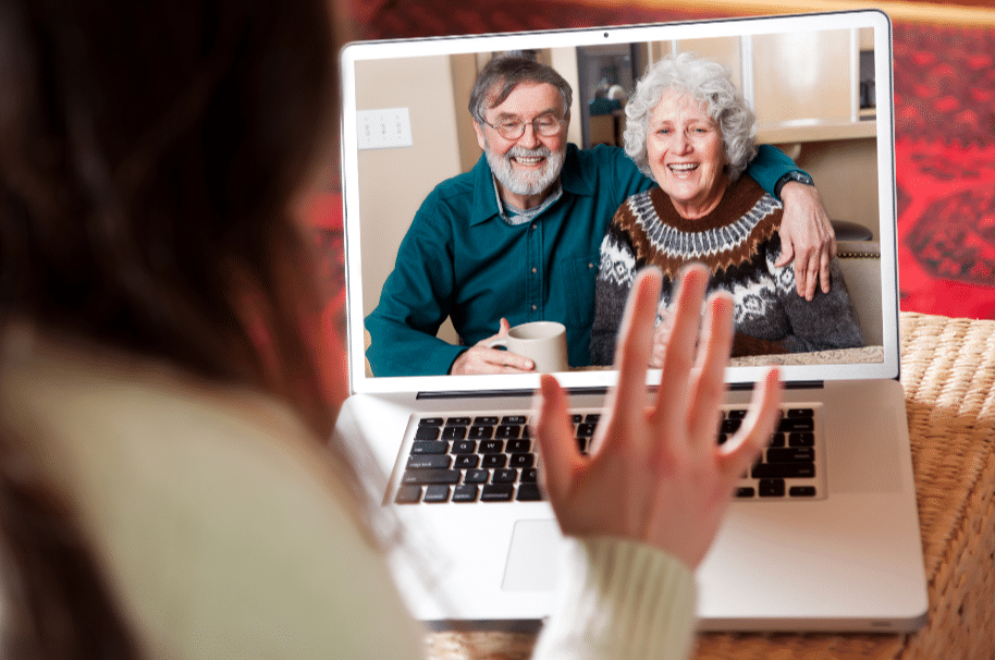 Man & woman face timing on their computer