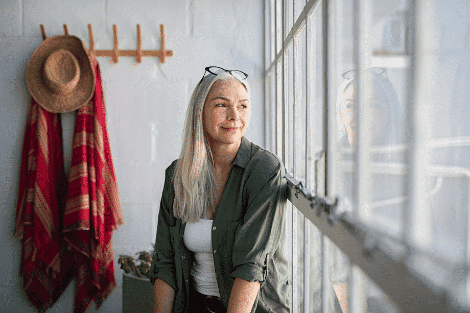 Woman looking out the window smiling