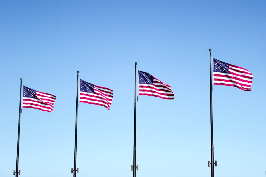 Four United States of American flags flying at full staff