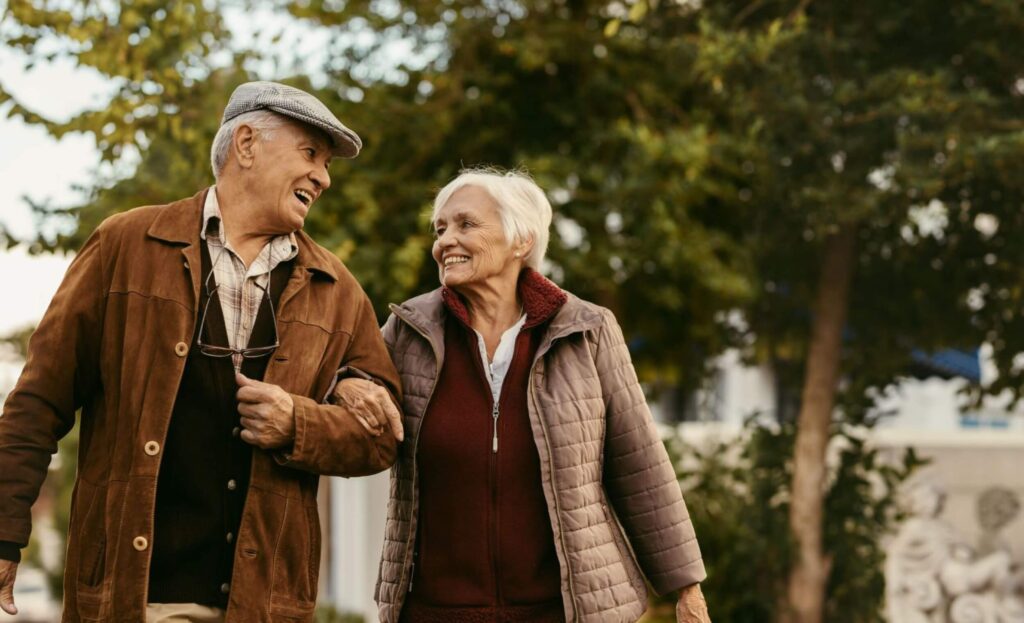 Autumn like photo of man & woman walking in the park