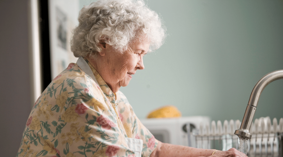 Woman washing her hands under a faucet of running water