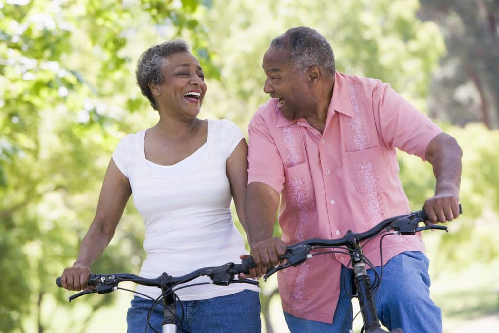 Man & woman outdoors riding their bikes
