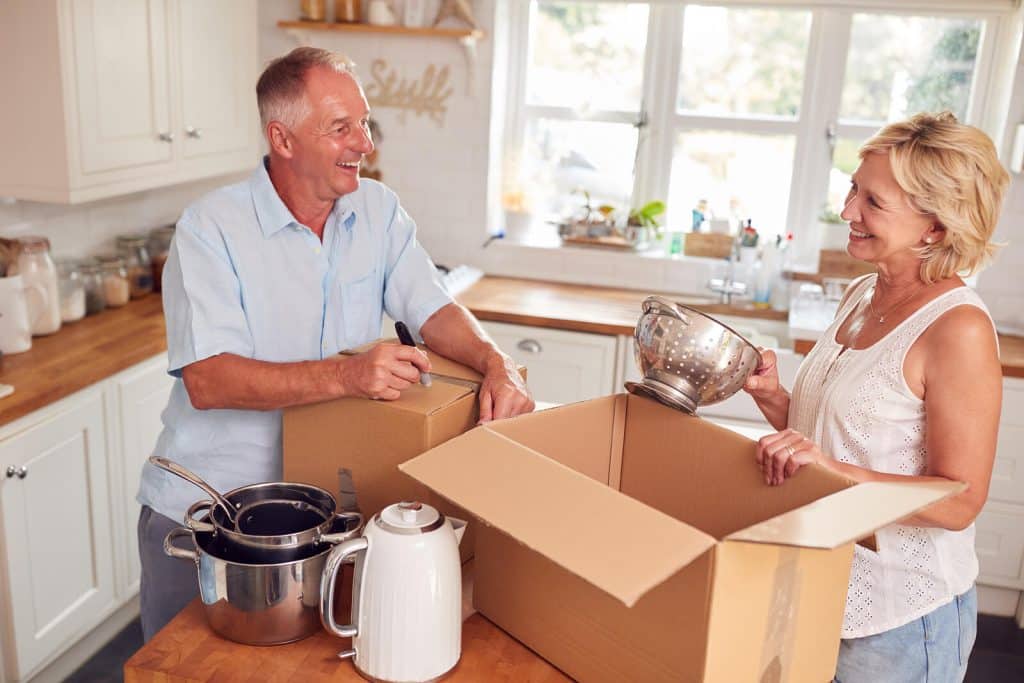 Man & woman unpacking kitchen utensils