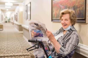Photo of women sitting in the common area reading the newspaper