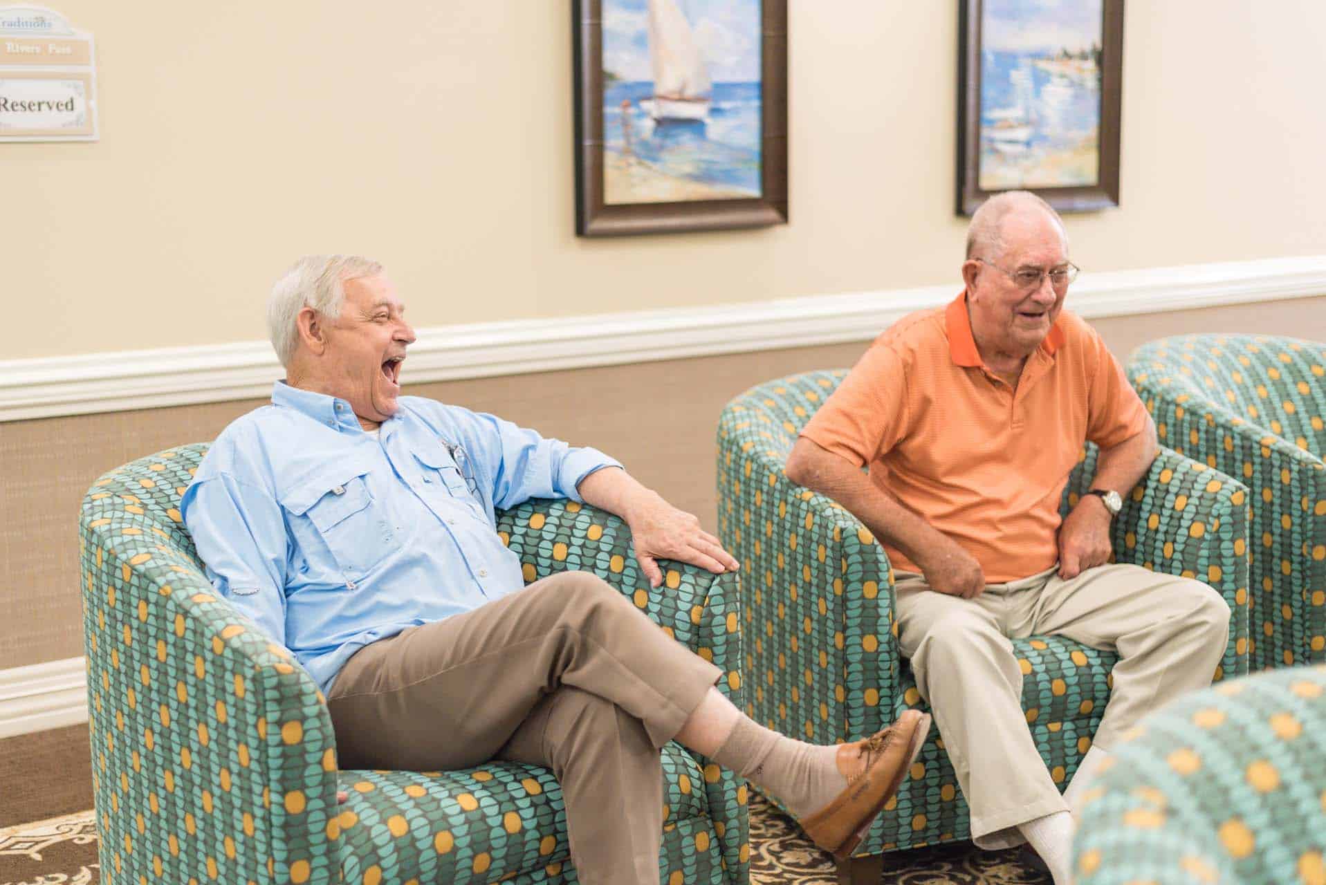 Photo of two men sitting the common area laughing