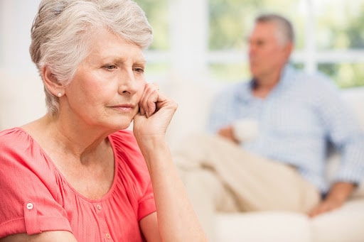 Woman and man sitting with serious expressions on their faces