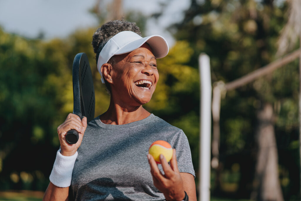 A senior woman about to play tennis