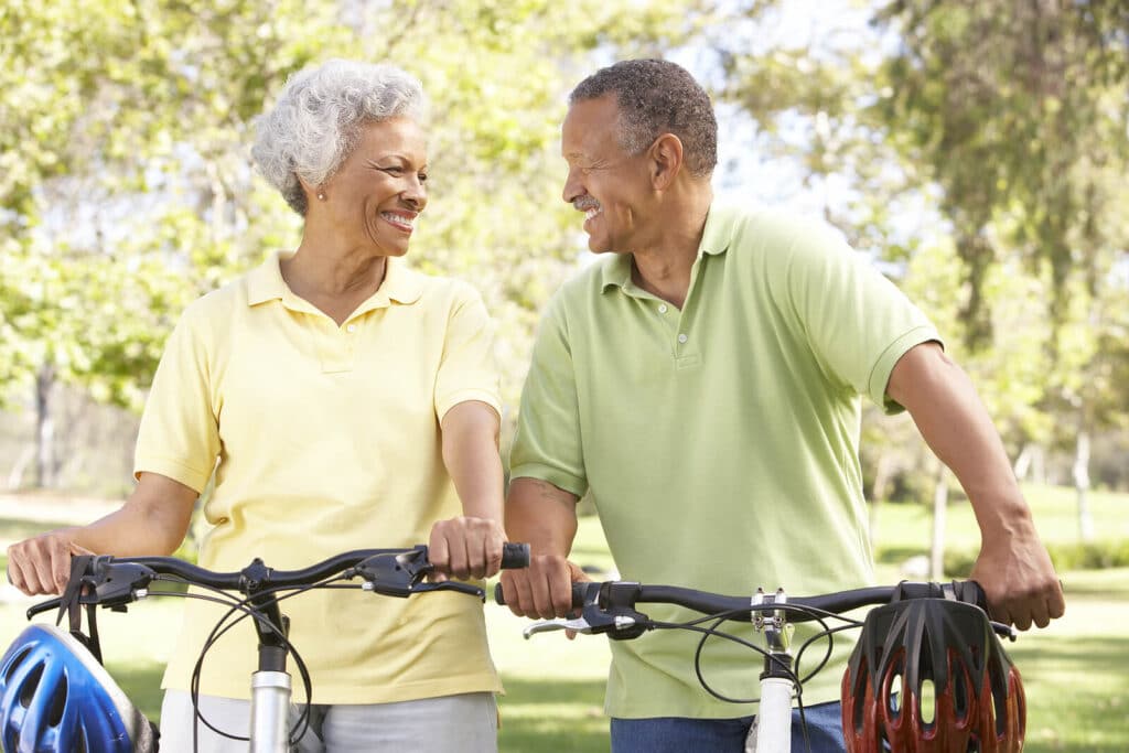 Man & woman outdoors riding their bikes