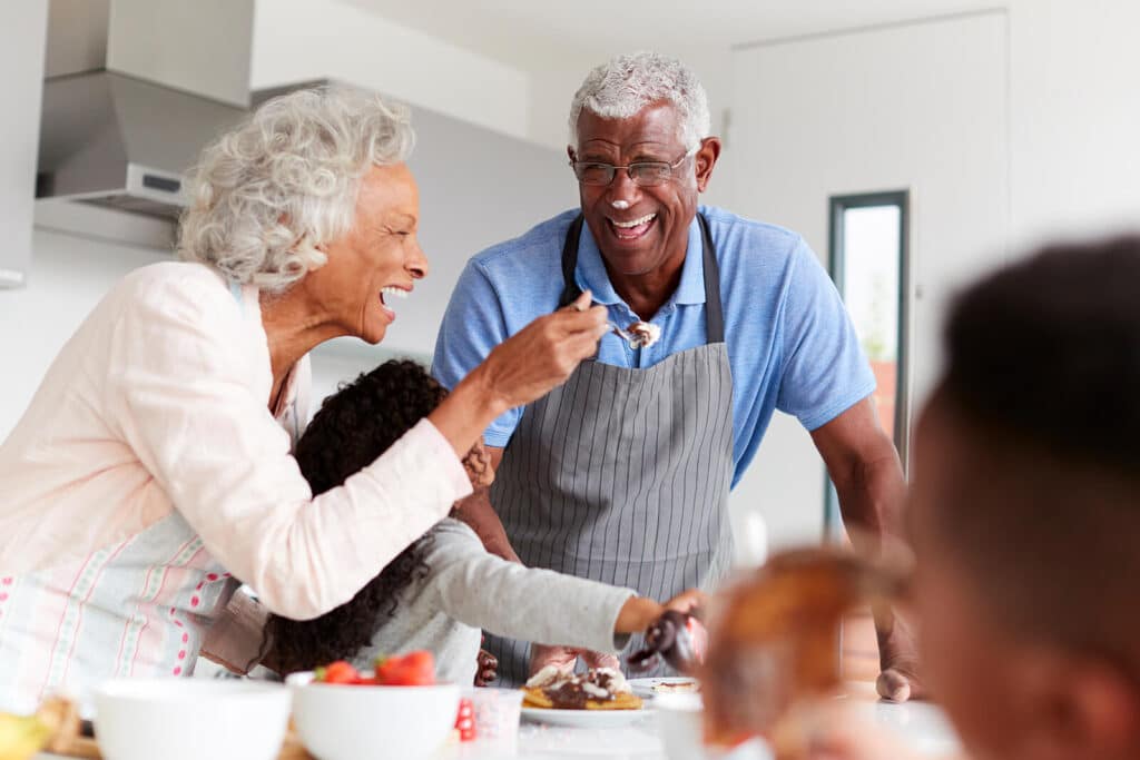 Man & woman sharing treats with two young children