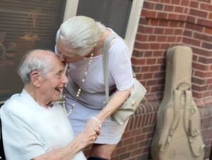 Photo of woman giving a man a kiss on his forehead