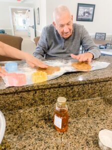 Photo of man learning how to bake and cut out shapes