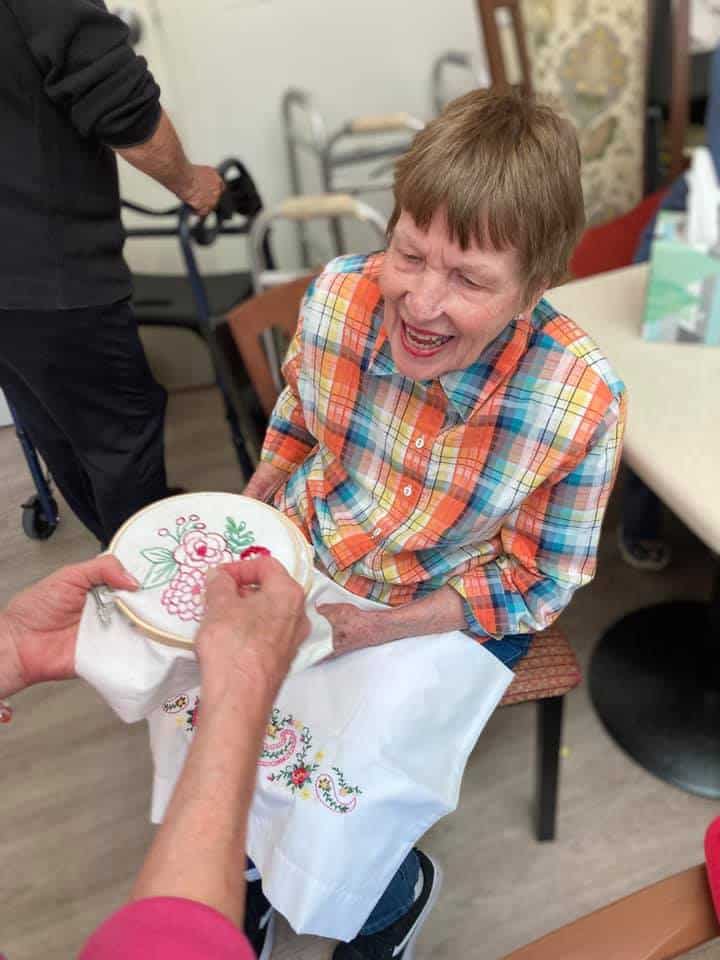 Retiree embroidering with a smile