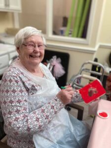 Retiree painting a red heart