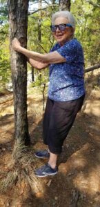 Senior resident hugging tree