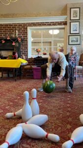 senior man bowling with a watermelon