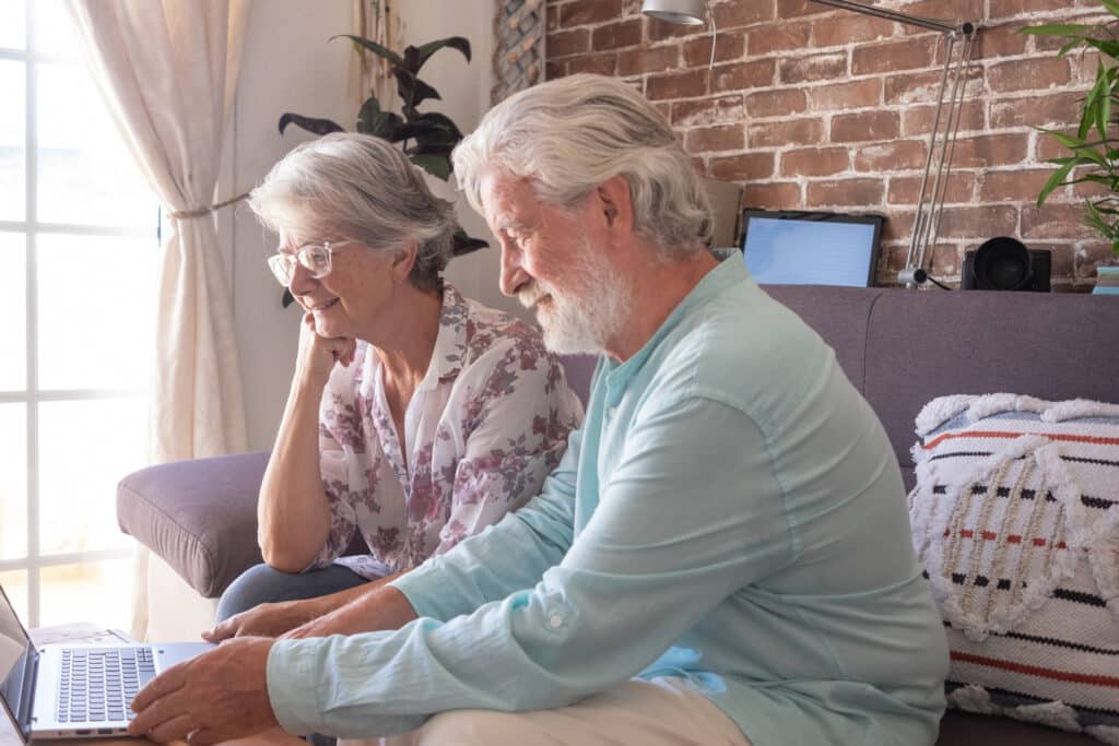 A couple watching something on their laptop