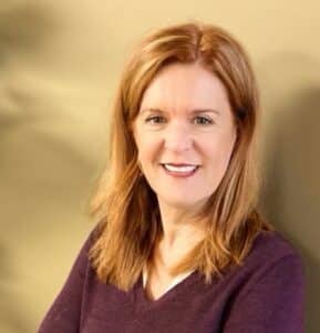 Headshot of woman with red hair smiling