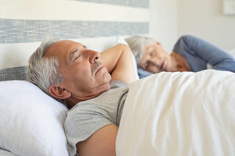 Senior couple sleeping, promoting healthy sleep habits
