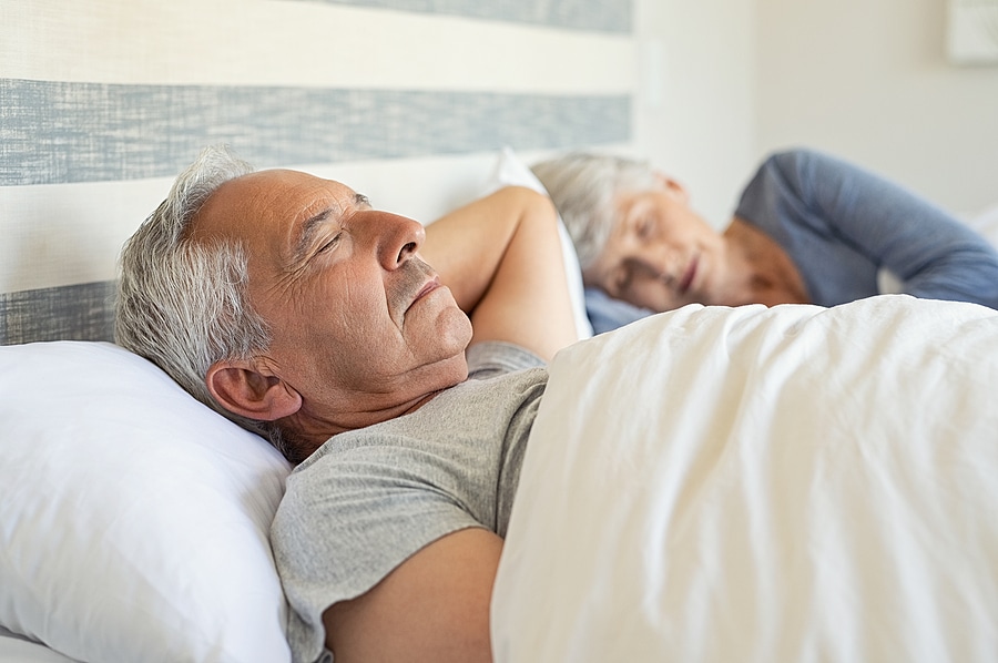 Senior couple sleeping, promoting healthy sleep habits