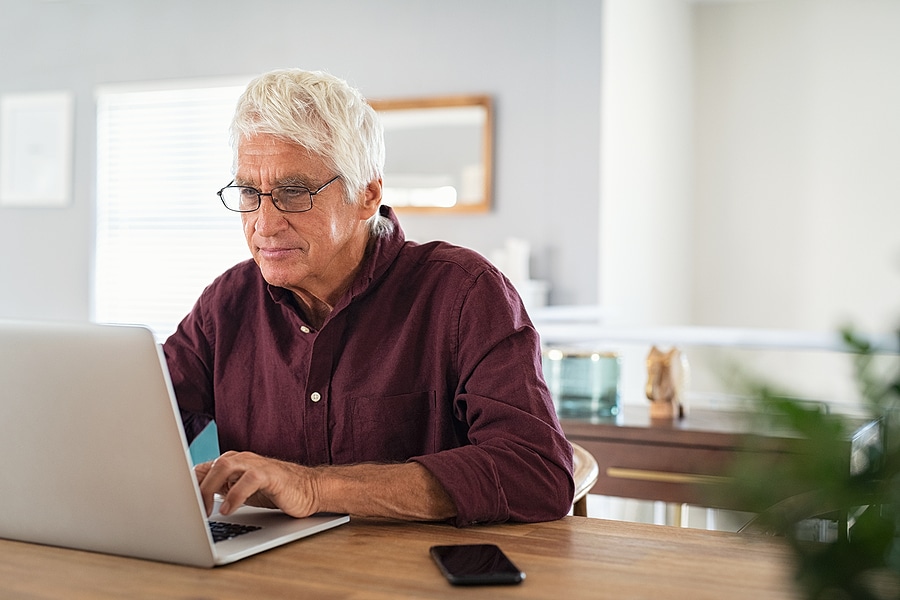 Senior man online researching senior living myths