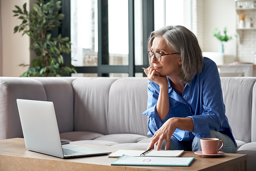 Senior woman sitting down evaluating her senior living options