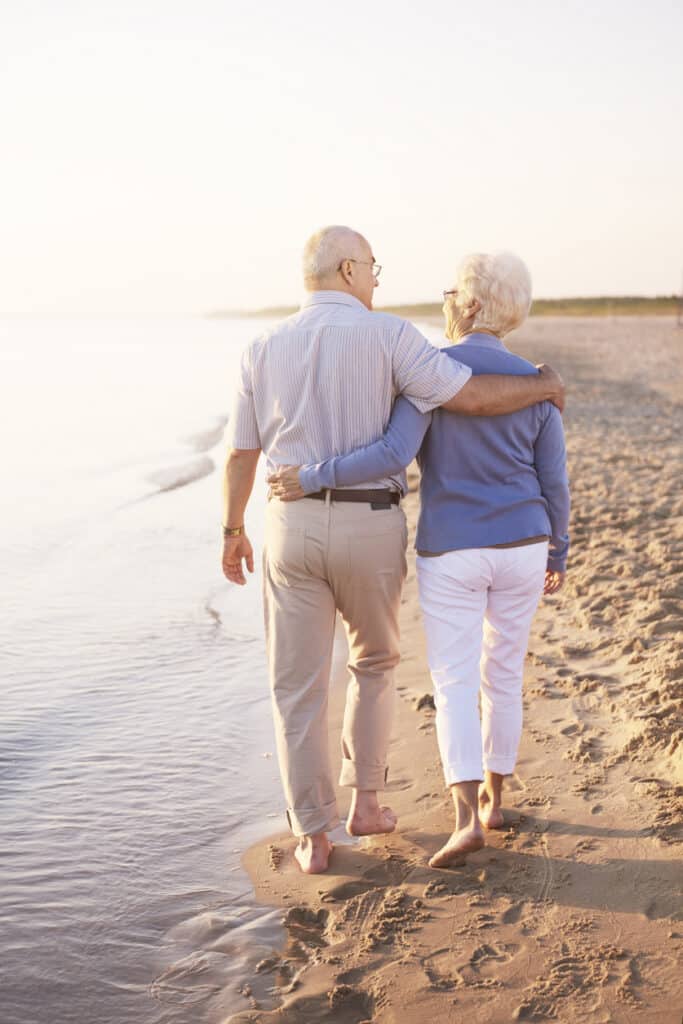 Senior couple walking on the beach