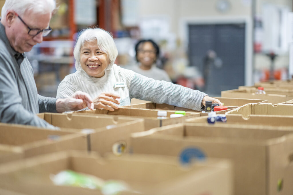 Seniors volunteering, filling up donation boxes
