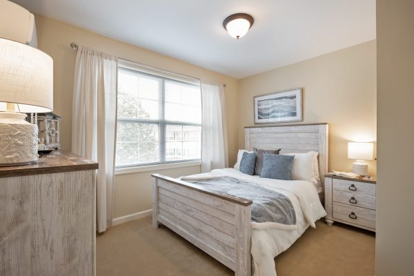 Model bedroom with bed and furniture