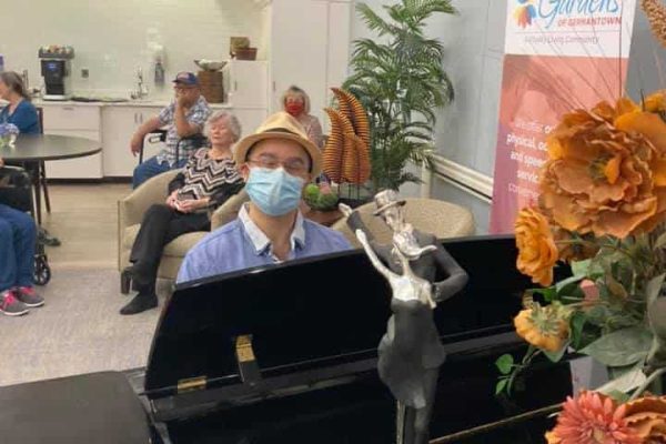 Man playing the piano at The Gardens of Germantown