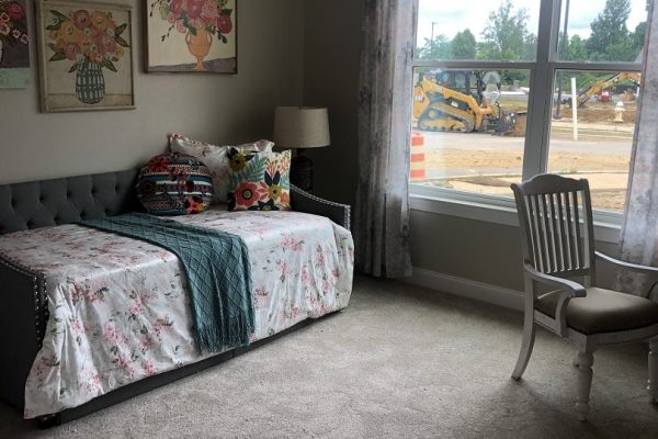 Model bedroom with bed and large window