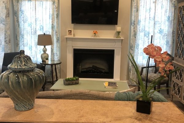 Model living room with fireplace and TV