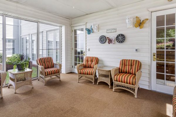Sunroom with large windows and lots of chairs