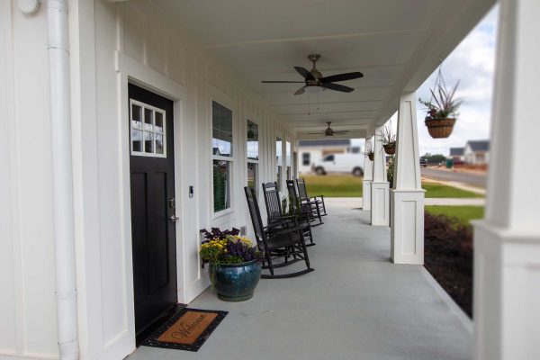Porch with rocking chairs in front of apartment